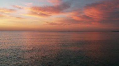 Picturesque sunrise over calm smooth waters of Mediterranean Sea. Sunny morning glow. Travel and tourism concept