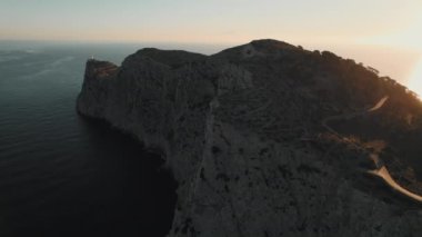 Drone point of view to The Formentor Lighthouse on rocky mountains top surrounded by waters of Mediterranean Seascape. Balearic Islands. Spain