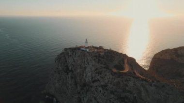 Drone point of view to The Formentor Lighthouse on rocky mountains top surrounded by waters of Mediterranean Seascape. Balearic Islands. Spain