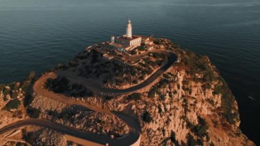 Drone point of view to The Formentor Lighthouse on rocky mountains top surrounded by waters of Mediterranean Seascape. Balearic Islands. Spain