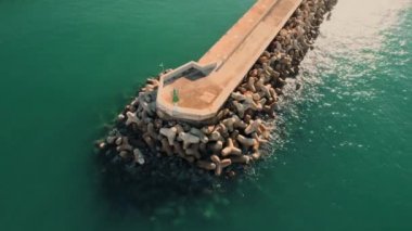 Aerial shot, drone point of view breakwaters surrounded by green waters of Mediterranean Sea of Santa Ponsa, small town in the southwest of Mallorca. Baleares, Spain