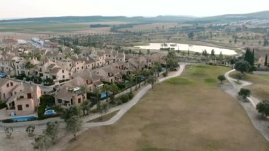 Typical Spanish golf fields and houses. Green lawns, palm trees and lakes for golf sport. Green area, tropical climate, aerial drone point of view. Province of Alicante. Costa Blanca. Spain