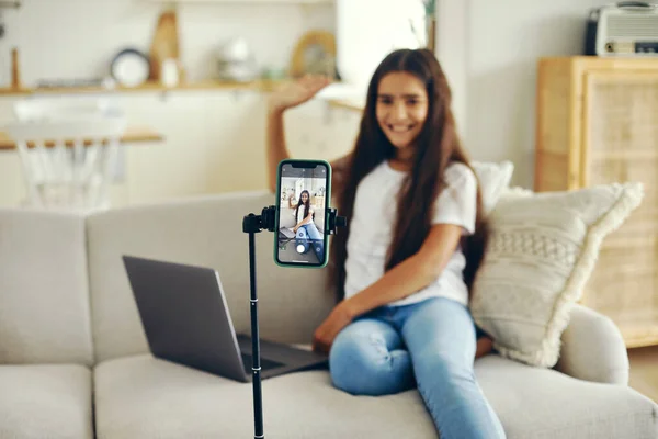 stock image Girl blogger sit on sofa greeting virtual friends, record video for vlog, make call, lead stream with friends use modern tech. Streamer activity, igeneration, fun and home use internet. Communication