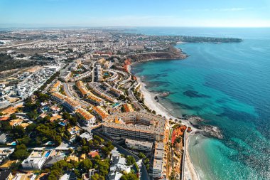 Picturesque panoramic drone point of view of Dehesa de Campoamor and Cabo Roig seaside and townscape, view from top. Alicante, Costa Blanca, Spain. Travel destinations and tourism concept clipart