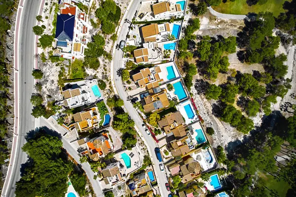 Drone point of view of luxury villas with swimming pools during sunny summer day. Real-estate, new build property and development concept. Spain, Costa Blanca, Las Ramblas. Alicante Province