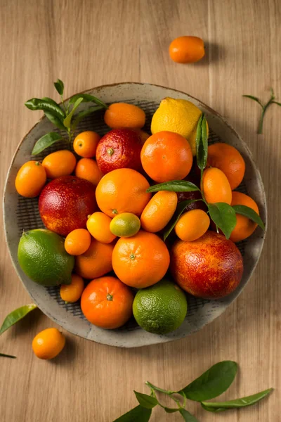 木桌上有一大盘多汁的柑橘类水果 — 图库照片