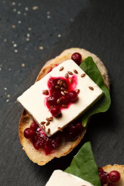 Keçi peynirli sandviç, yaban mersini reçeli ve keten tohumu.