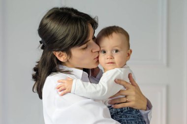 Portrait of young happy mother with a small child