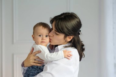 Portrait of young happy mother with a small child