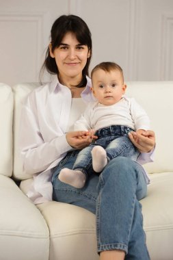 Portrait of young happy mother with a small child