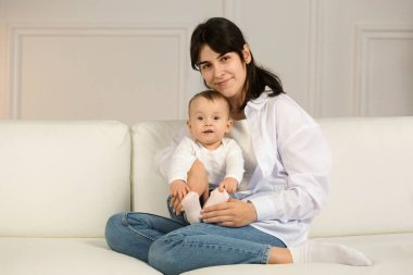 Portrait of young happy mother with a small child