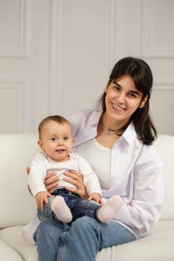 Portrait of young happy mother with a small child
