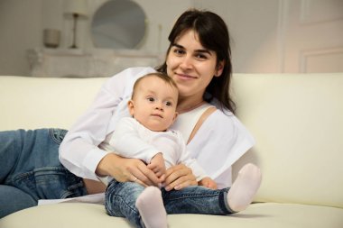 Portrait of young happy mother with a small child