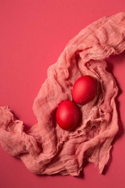 Pink chicken eggs on pink gauze on a pink background. Color Viva Magenta 18-1750, in 2023
