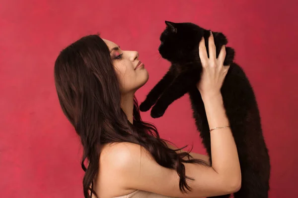 Beautiful Woman Holding Black Cat Pink Background Stok Gambar