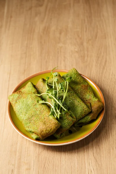 Green Pancakes Spinach Young Pea Shoots Plate Wooden Table — Zdjęcie stockowe