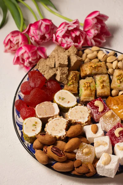 Pembe laleli hafif bir arka planda doğulu tatlılarla dolu bir hayat