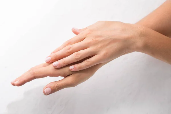 stock image Female hands with minimalist french manicure on white background