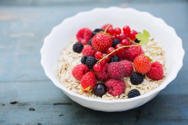Beyaz kasede yulaf ezmesi ve böğürtlen