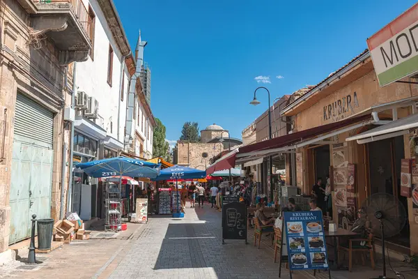 Lefkoşe, Kıbrıs - 24 Ekim 2022: Dükkan ve restoranlarla dolu dar bir Arasta caddesinde yürüyen turistler