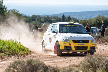 Anogyra, Cyprus - January 29, 2023: Suzuki Swift Sport MK4 speeding on dirt road raising dust at Anogyra Rally Sprint 2023 clipart