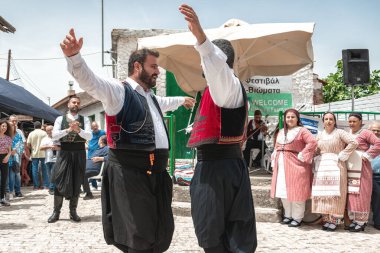 Dora (Dhora), Limassol District, Cyprus - May 28, 2023: Men in traditional Cypriot costumes dancing at Dora village festival clipart