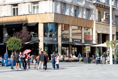 Belgrad, Sırbistan - 20 Eylül 2019: Sırbistan 'ın Belgrad kentindeki Cumhuriyet Meydanı' nda elinde pembe şemsiyeyle tur rehberini dinleyen turistler