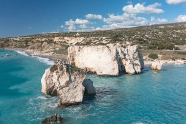 Turquoise water surrounding Aphrodite's rock on beautiful sunny day in Cyprus clipart