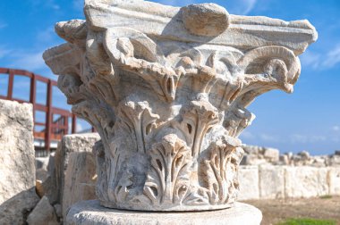 Kıbrıs Rum Kesimi 'ndeki Kourion harabelerinde akanthus yaprağı oymalarının altını çizen yıpranmış bir korint başkentine yakın çekim