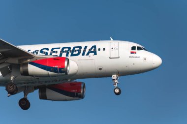 Larnaca, Kıbrıs - 29 Haziran 2024: Air Serbia uçakları açık mavi gökyüzüne doğru süzülüyor