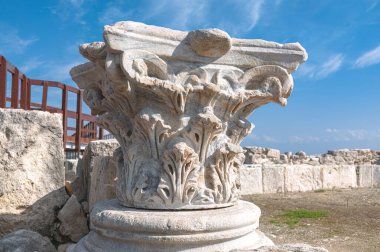 Ancient Corinthian column capital standing on a stone base at Kourion archaeological site in Cyprus. Episkopi, Limassol District