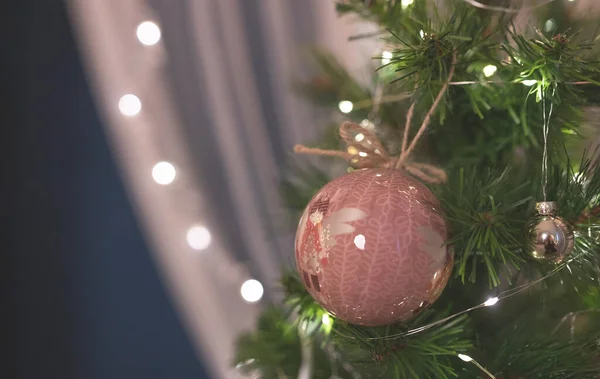 Winter, holidays and decoration concept - Christmas ball on Christmas fir tree