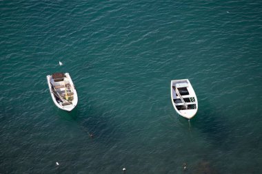 View of the Port of Corricella with lots of colorful houses on a sunny day in Procida Island, Italy.