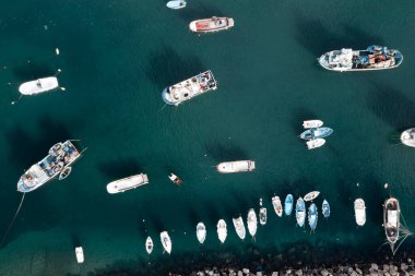 View of the Port of Corricella with lots of colorful houses on a sunny day in Procida Island, Italy.