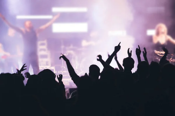 Stock image Crowd at concert - Cheering crowd in front of bright colorful stage lights