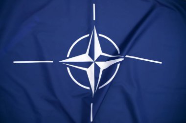NATO (North Atlantic Treaty Organization) flag waving. NATO is an international military alliance that constitutes a system of collective security
