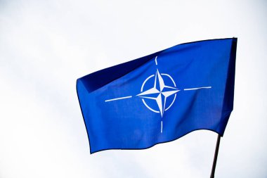 NATO (North Atlantic Treaty Organization) flag waving. NATO is an international military alliance that constitutes a system of collective security