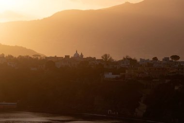 Magic sunset over Procida Island with Ischia island in the background.