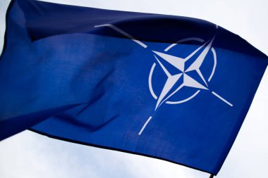 NATO (North Atlantic Treaty Organization) flag waving. NATO is an international military alliance that constitutes a system of collective security