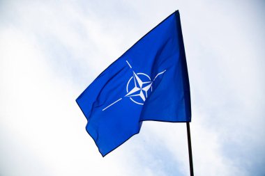 NATO (North Atlantic Treaty Organization) flag waving. NATO is an international military alliance that constitutes a system of collective security