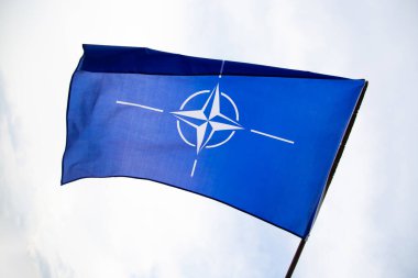 NATO (North Atlantic Treaty Organization) flag waving. NATO is an international military alliance that constitutes a system of collective security