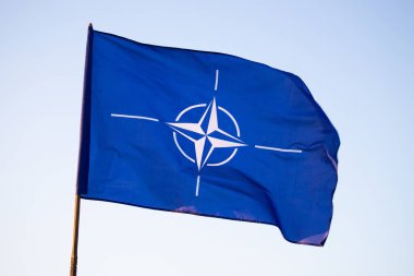 NATO (North Atlantic Treaty Organization) flag waving. NATO is an international military alliance that constitutes a system of collective security