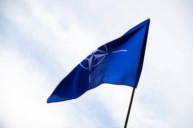 NATO (North Atlantic Treaty Organization) flag waving. NATO is an international military alliance that constitutes a system of collective security