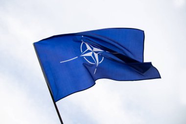 NATO (North Atlantic Treaty Organization) flag waving. NATO is an international military alliance that constitutes a system of collective security