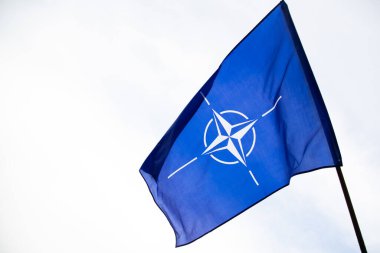 NATO (North Atlantic Treaty Organization) flag waving. NATO is an international military alliance that constitutes a system of collective security