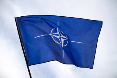 NATO (North Atlantic Treaty Organization) flag waving. NATO is an international military alliance that constitutes a system of collective security