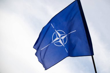 NATO (North Atlantic Treaty Organization) flag waving. NATO is an international military alliance that constitutes a system of collective security