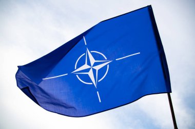 NATO (North Atlantic Treaty Organization) flag waving. NATO is an international military alliance that constitutes a system of collective security