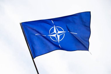 NATO (North Atlantic Treaty Organization) flag waving. NATO is an international military alliance that constitutes a system of collective security