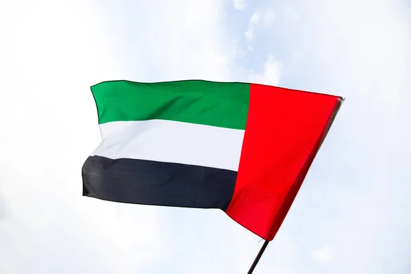 stock image United Arab Emirates flag flying against clean and tranquil sky. UAE celebrates it's national day on 2nd December every year.